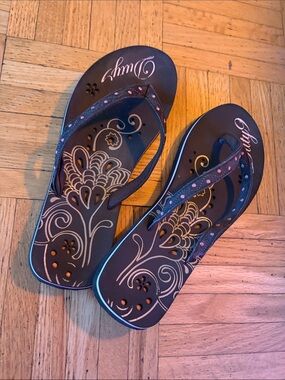 Vintage flip flops with flower detailing on the bottom and polka dot straps